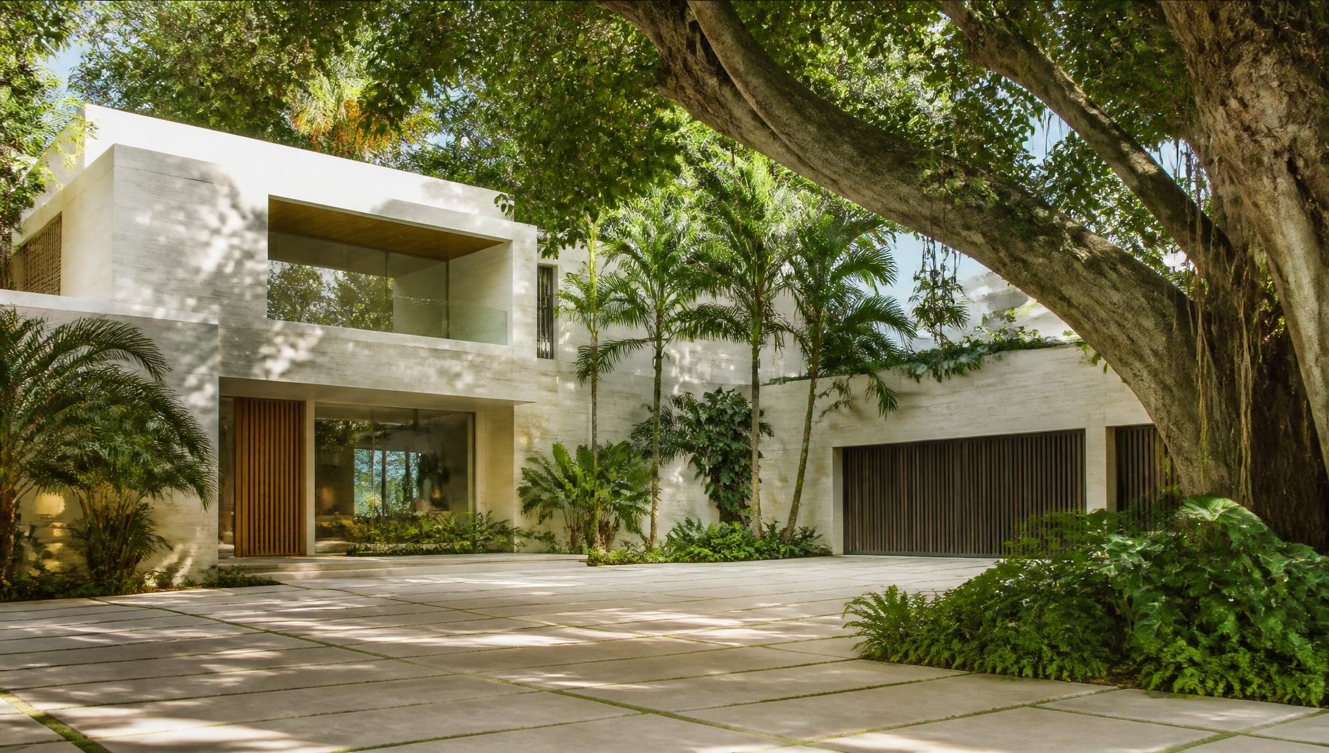 Contemporary Coconut Grove residence set under a dense banyan and palm canopy in Miami